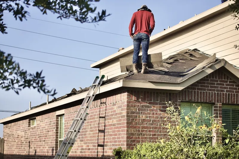 Professional roofer working on a residential roof in Berkeley Manor